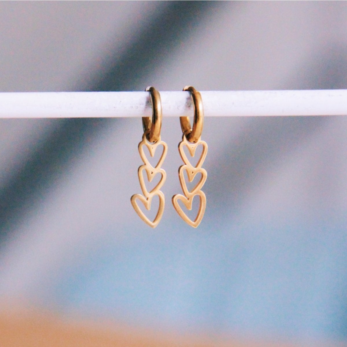 Stainless steel earrings with 3 slanted hearts - gold